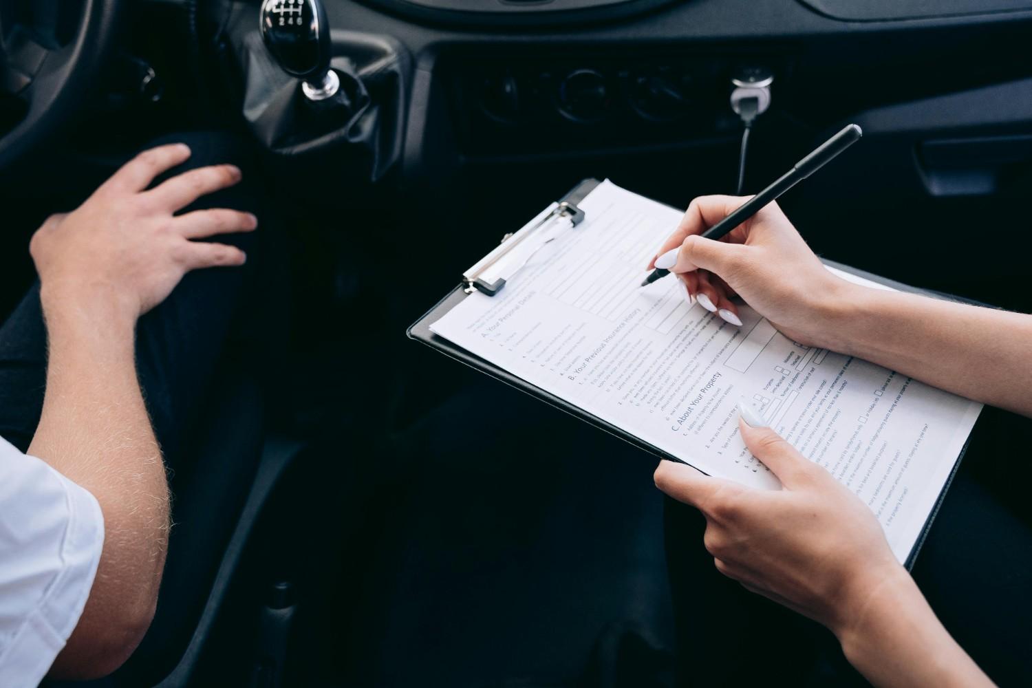 A professional insurance agent handing car keys to a happy driver next to a modern sedan, symbolizing a successful insurance policy match